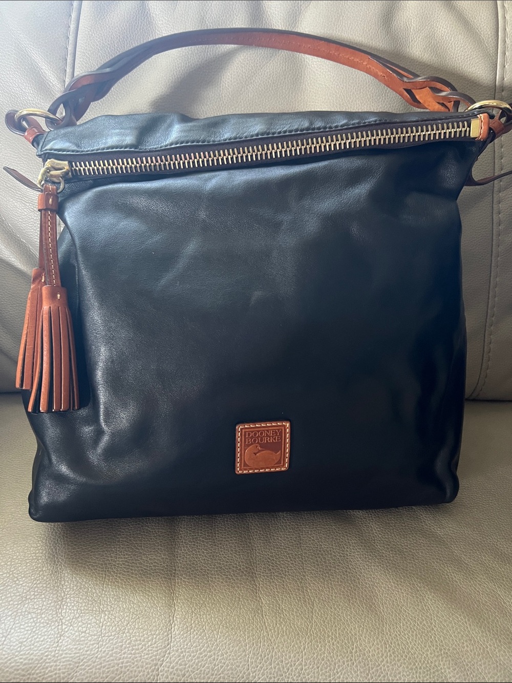 Dooney & Bourke Black Leather Shoulder Bag with Brown Trim and Tassel